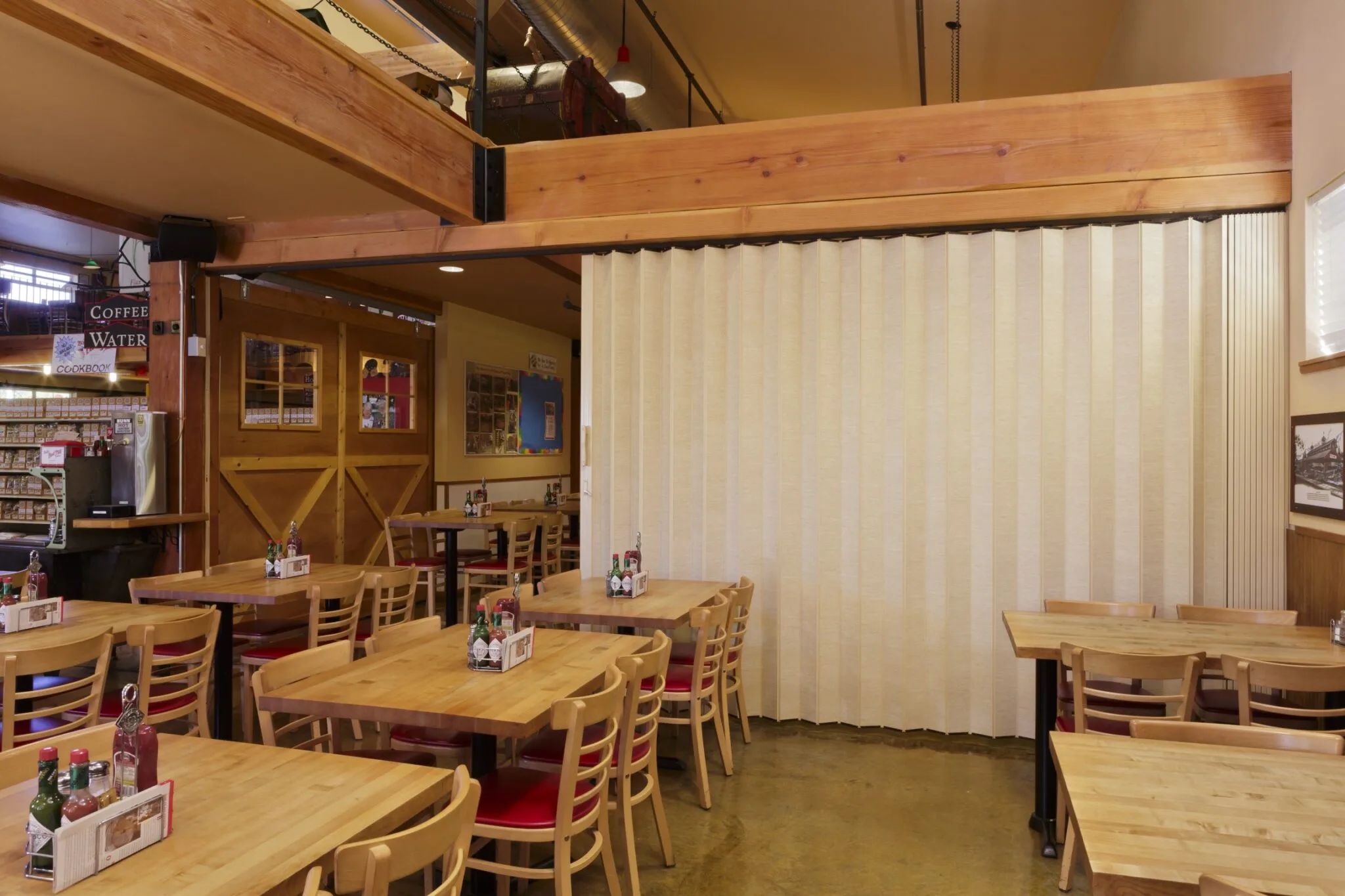 Woodfold accordion door dividing a dining room
